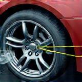 Image representing wheel alignment equipment adjusting a car wheel
